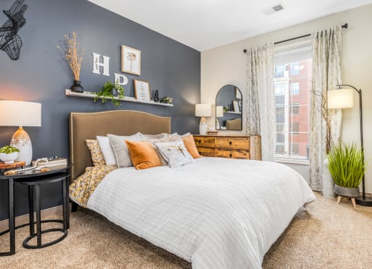 a bedroom with a bed and a window
