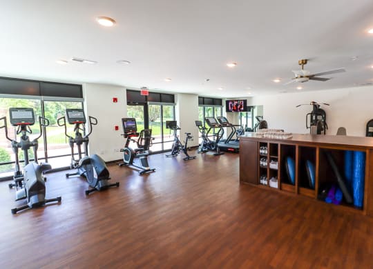 a room with a lot of exercise equipment and a counter