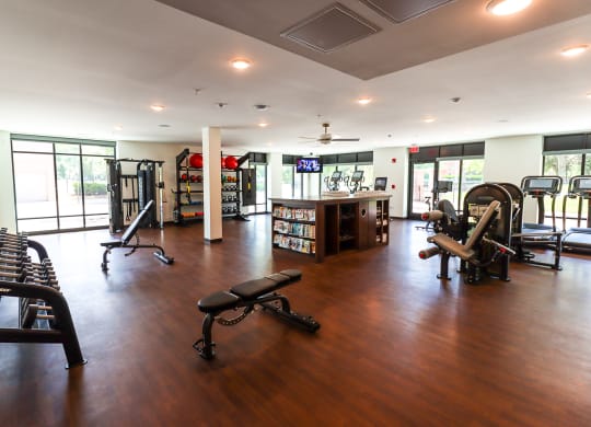 a large fitness room with a lot of exercise equipment