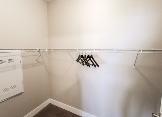 a walk in closet in a bedroom