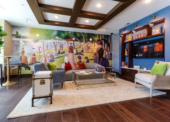 a living room with a large mural on the wall