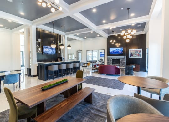 a communal area with tables and chairs and a fireplace