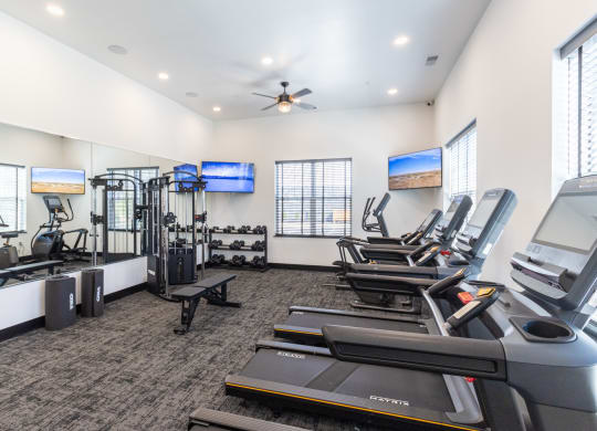 the gym with treadmills and cardio equipment at the belgard apartments