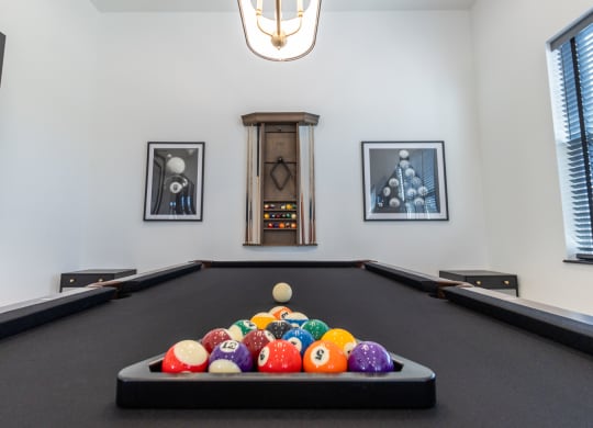 a billiards table with a bunch of balls on it