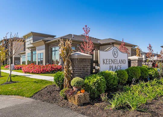 A Keeneland Place sign is displayed in front of a building.