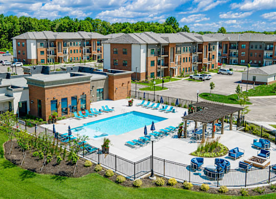 A large building with a pool in front of it.