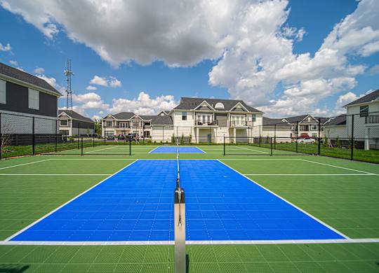 A tennis court with a blue surface and white lines.