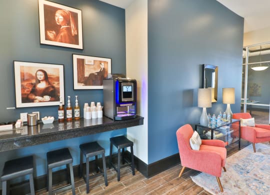 a hotel lobby with a bar with chairs and a coffeemaker