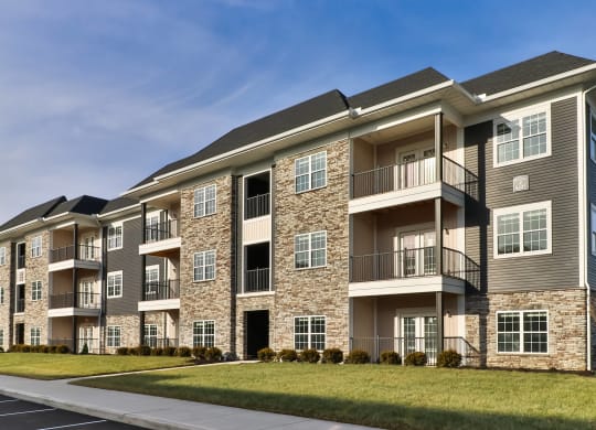 an exterior view of an apartment building on a sunny day