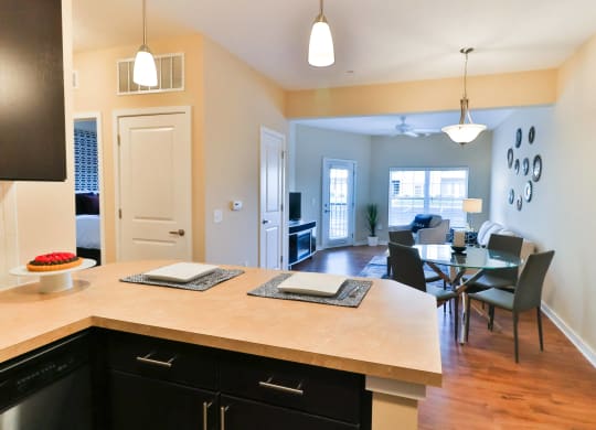 a kitchen and dining area with a table and chairs and a large counter top