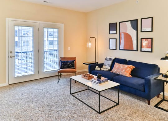 a living room with a blue couch and a coffee table