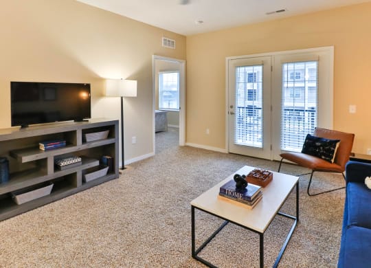 a living room with a couch and a coffee table and a television