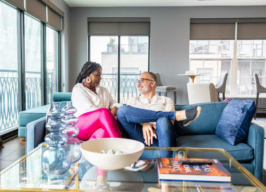 two people sitting on a couch in a living room
