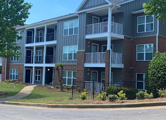 A multi-story apartment building with balconies and doors.
