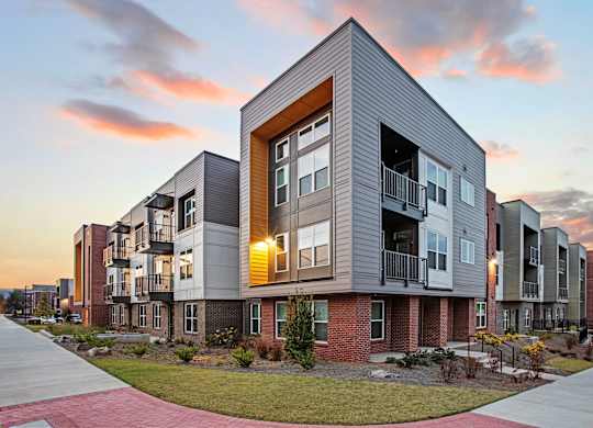 A modern apartment building with a mix of brick and panel exterior walls.