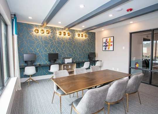 A conference room with a long table and chairs.