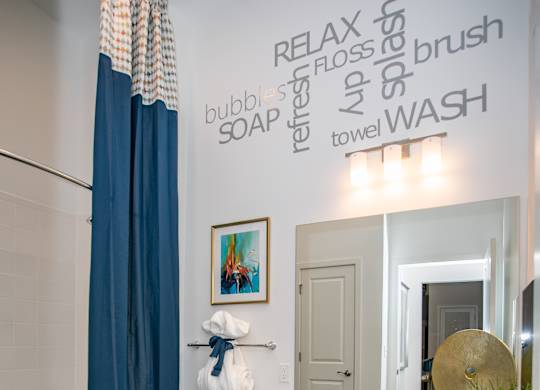 A bathroom with a toilet, sink, and a shower curtain.