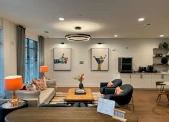 A living room with a sofa, armchairs, and a coffee table.
