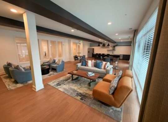 A modern living room with a large window and a wooden floor.