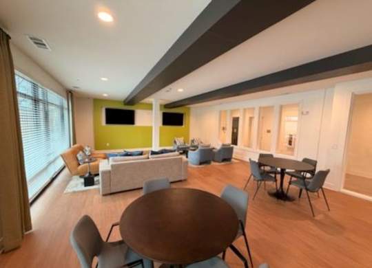 A modern living room with a brown table and chairs.