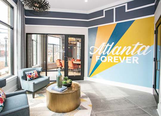 A living room with a large wall mural that says