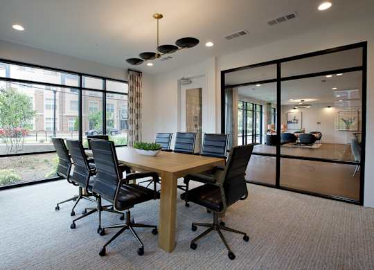 A conference room with a long table and chairs.