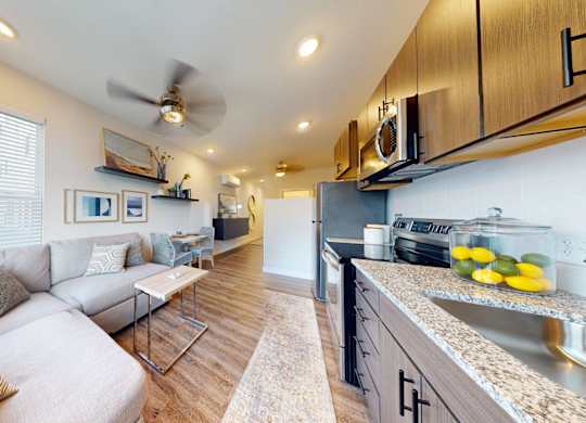 A modern kitchen with a dining area and a living room.