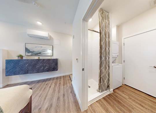 A bedroom with a bed, a dresser, and a painting on the wall.