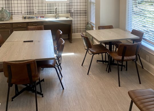 A kitchen with a table and chairs.