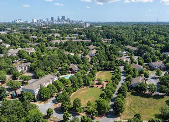 A suburban area with a city skyline in the distance.