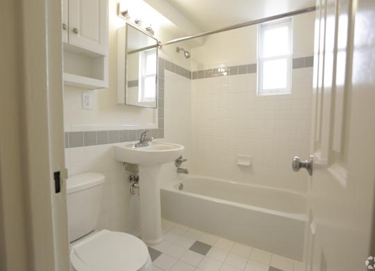a bathroom with a sink toilet and bath tub
