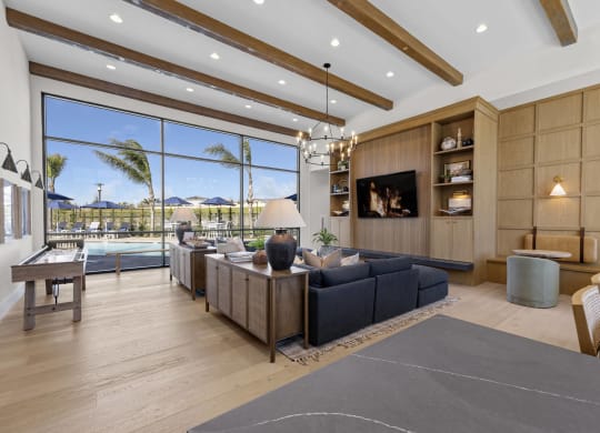 the living room has a large window overlooking the pool and the beachat Westbury Apartments, Rancho Cucamonga, California 