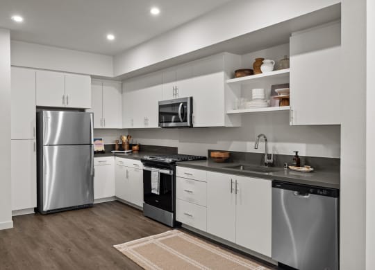 a kitchen with white cabinets and stainless steel appliancesat Westbury Apartments, Rancho Cucamonga, 91739