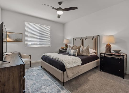 a bedroom with a bed and a ceiling fanat Westbury Apartments, Rancho Cucamonga, California