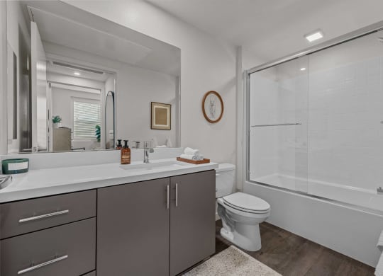 a bathroom with a shower and a sink and a toiletat Westbury Apartments, Rancho Cucamonga, California 