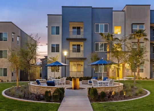 a courtyard with tables and chairs in front of an apartment buildingat Westbury Apartments, Rancho Cucamonga, CA