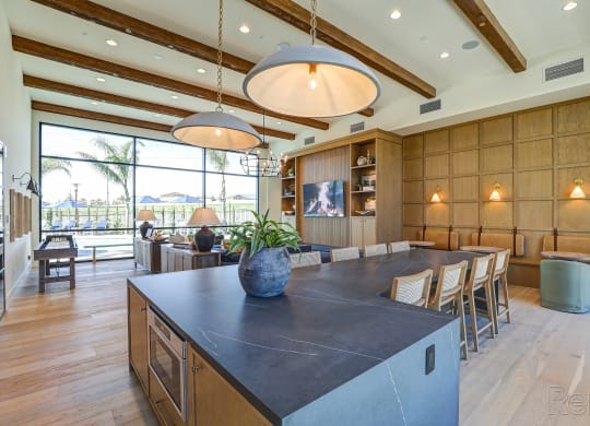 a large kitchen with a large island and a dining table  at Westbury Apartments, Rancho Cucamonga, CA