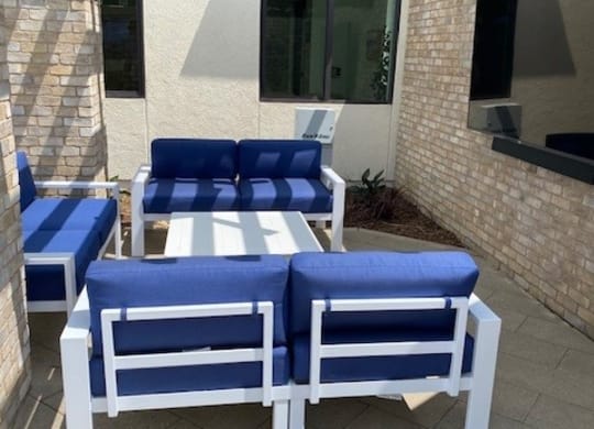 a group of blue and white chairs on a patioat Westbury Apartments, Rancho Cucamonga