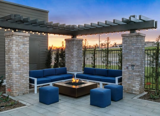 a patio with blue couches and a fire pitat Westbury Apartments, Rancho Cucamonga, California 