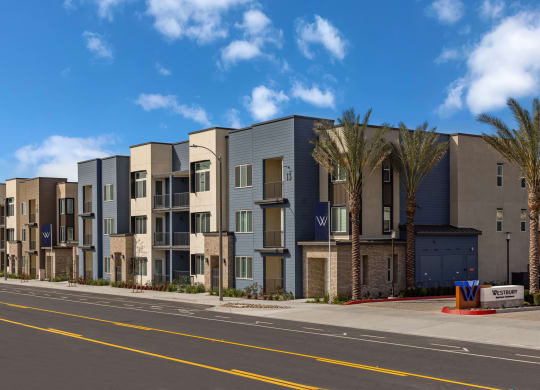 a street view of an apartment building with palm treesat Westbury Apartments, Rancho Cucamonga, California
