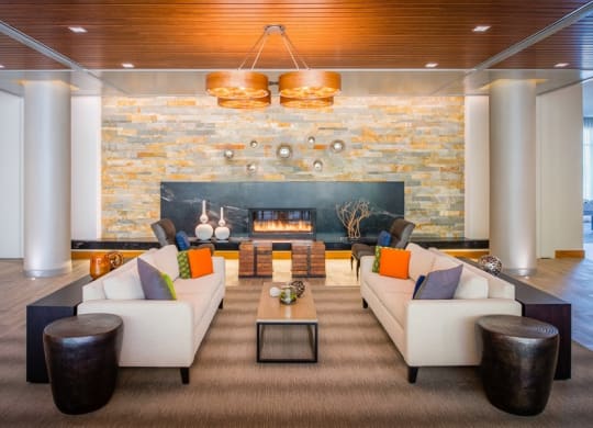 a living room with couches and a fireplace at The Metropolitan Downtown Columbia, Maryland, 21044