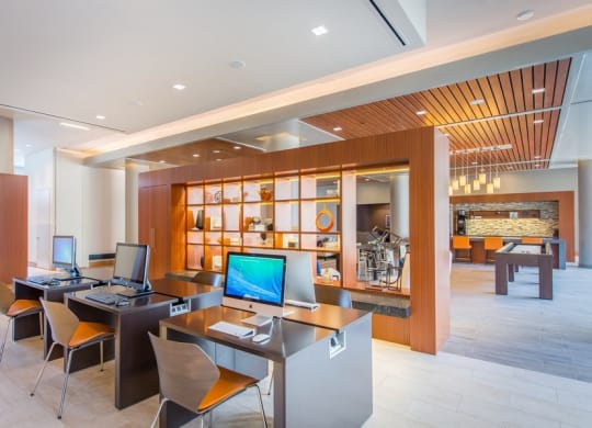 a computer lobby in a hotel with desks and chairs at The Metropolitan Downtown Columbia, Maryland