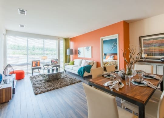 a living room and dining room with a table and chairs at The Metropolitan Downtown Columbia, Columbia, Maryland