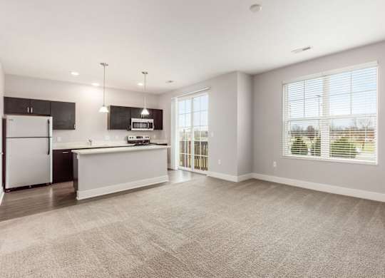A spacious kitchen with a refrigerator, microwave, and oven.