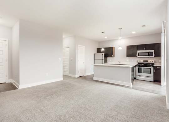 A spacious kitchen with a white countertop and modern appliances.