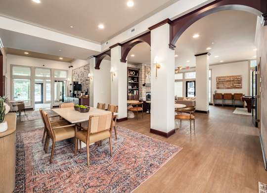 A large room with a dining table and chairs.