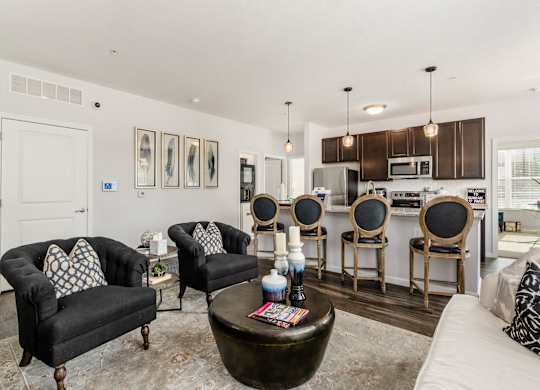 A living room with a black couch and a coffee table.