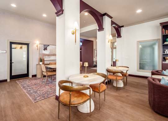 A living room with a round table and chairs.