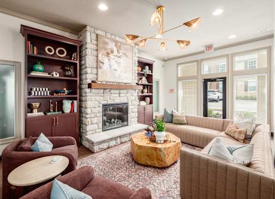 A living room with a fireplace and a large painting above it.