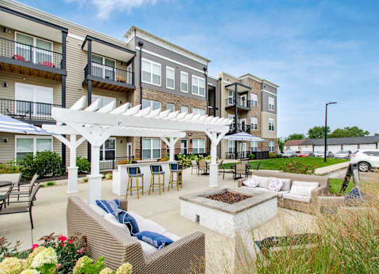 A sunny day at a residential outdoor patio with a white pergola.